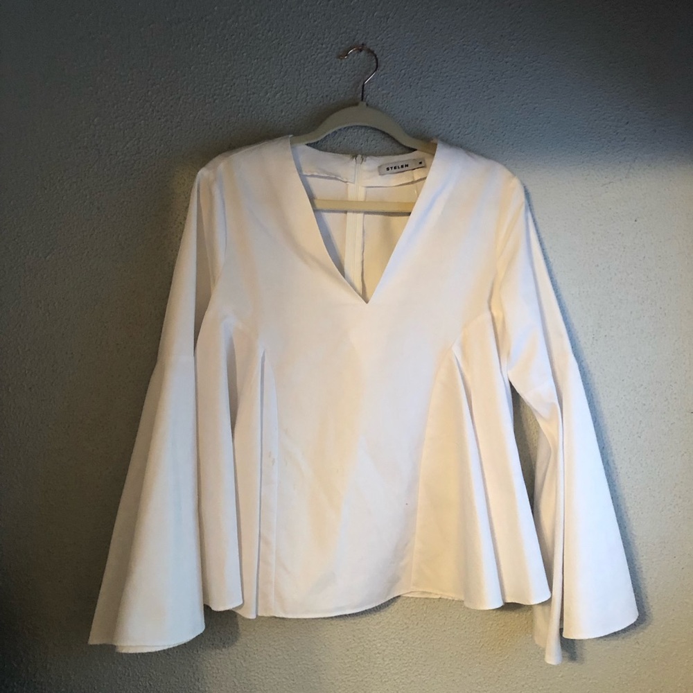 Crisp white top with bell sleeves v neck and darting